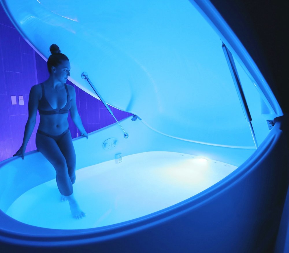 A lady standing in float tank. Wellspring Visionary